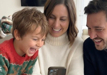 Boy watching AI Santa video message - magical Christmas reaction