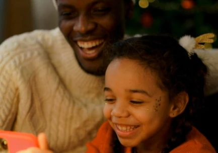 Family watching custom Santa video together - holiday memories